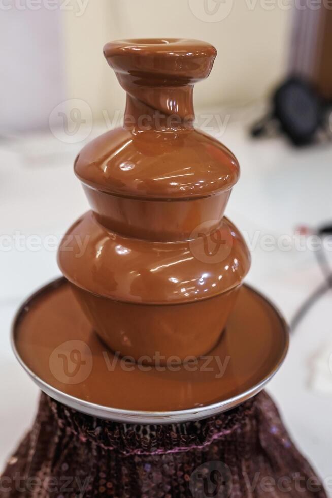 A chocolate fountain with a chocolate fountain on top photo