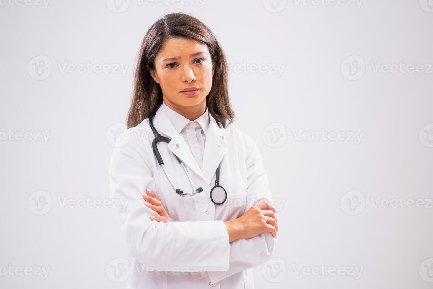 Studio shot portrait of female doctor who is sad, tired and overworked. photo