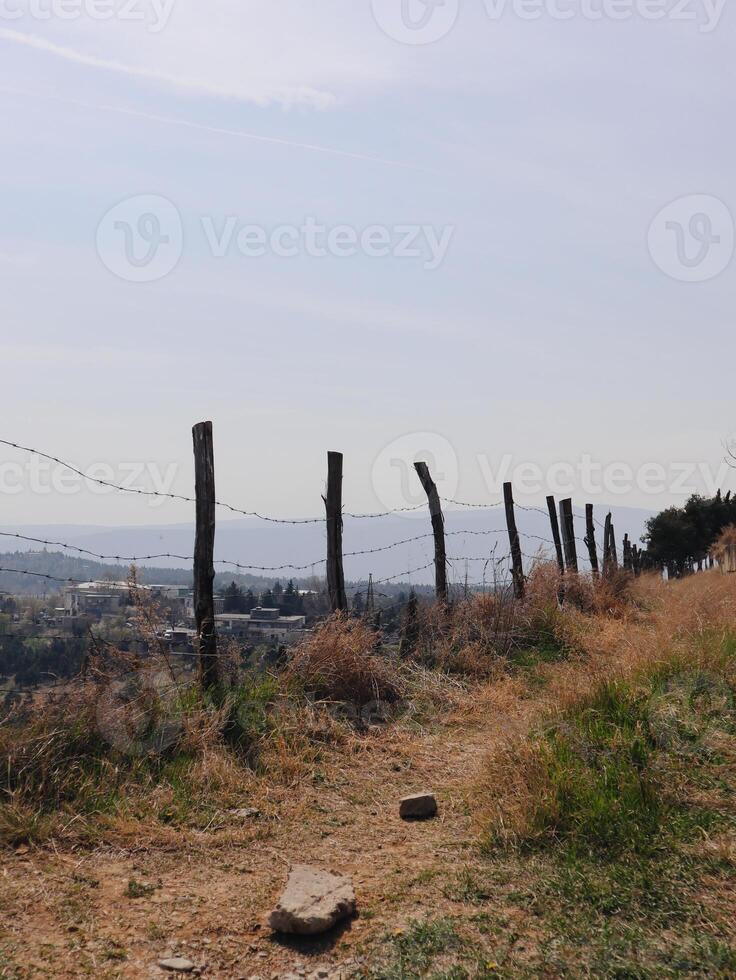 Rustic Fence Line Overlooking a Town photo