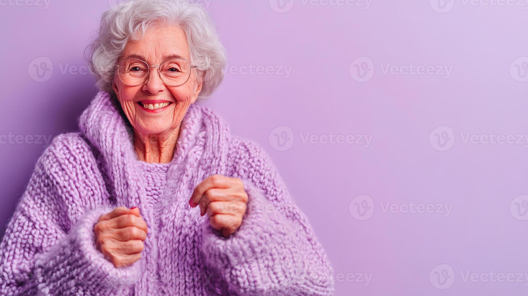 A Joyful Elderly Woman Dressed in a Cozy Sweater Posed Against a Vibrant Purple Background photo