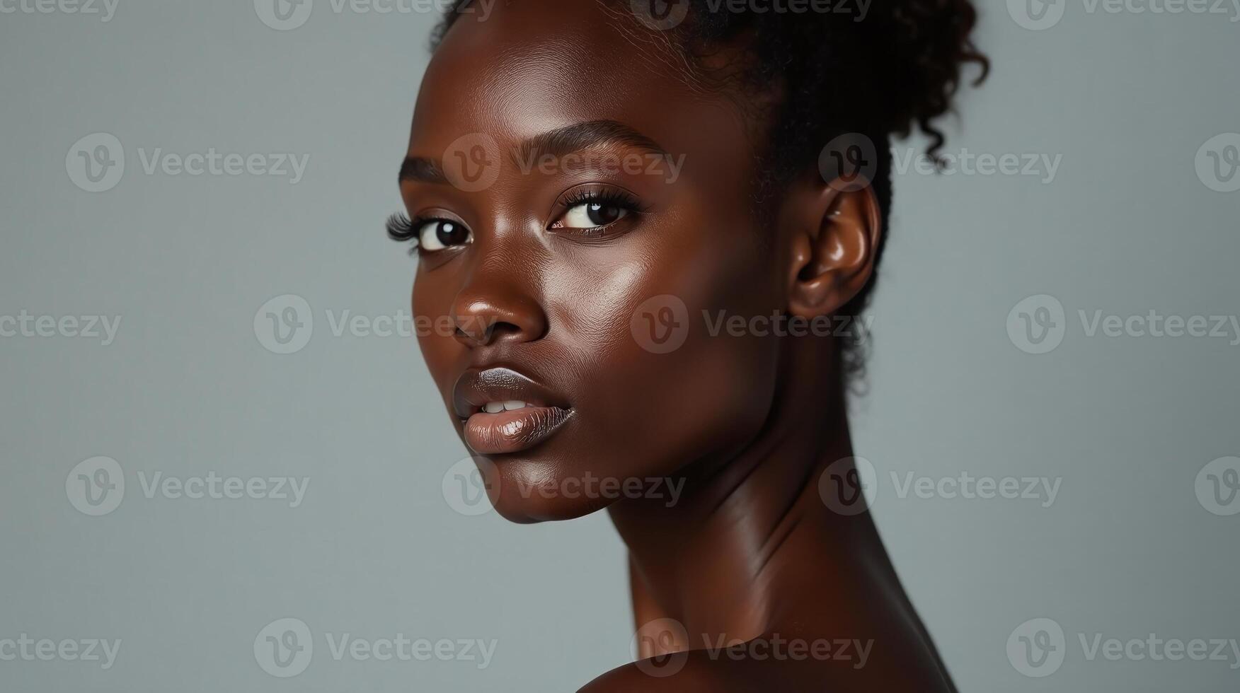 The image depicts a person with a smooth, glossy complexion against a plain background. photo