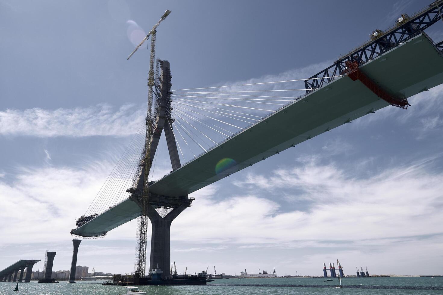 The bridge is being built over the water photo