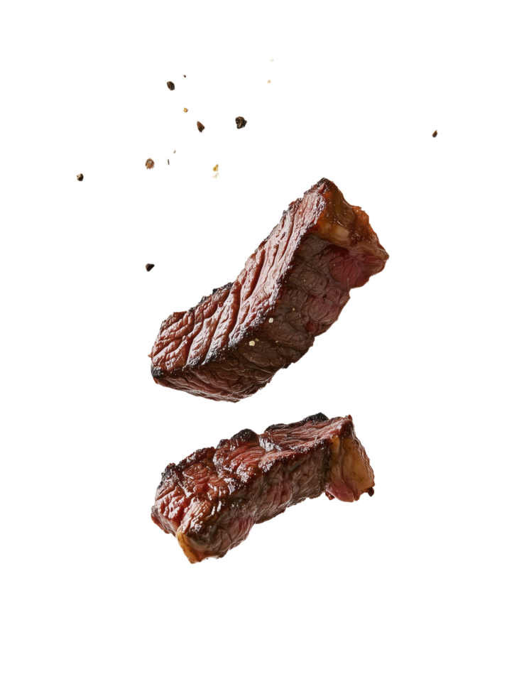 Seared steak pieces levitate against a dark backdrop accented by scattered spices promising a flavorful and visually striking culinary experience png