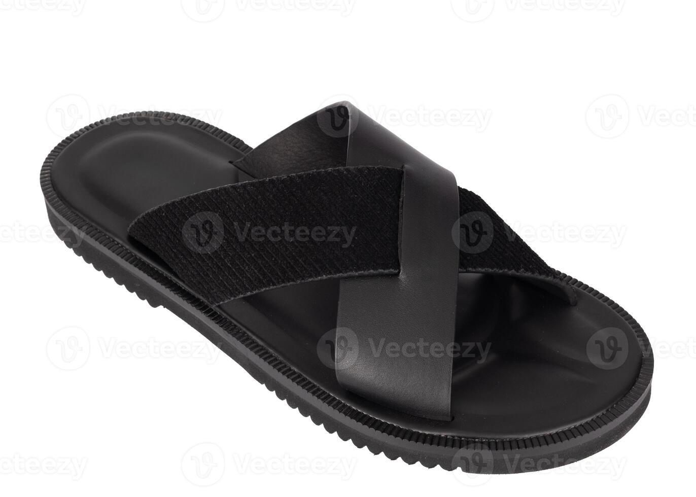 Angled view of modern black sandal with wide leather and fabric cross straps isolated on white background.. photo