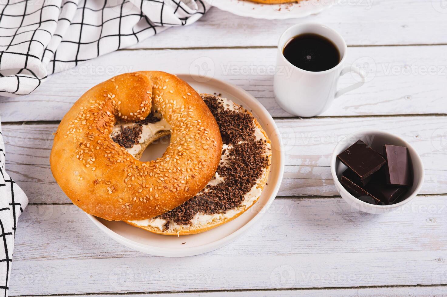 Sweet sandwich with butter, chocolate and sesame seeds on a plate on a table photo