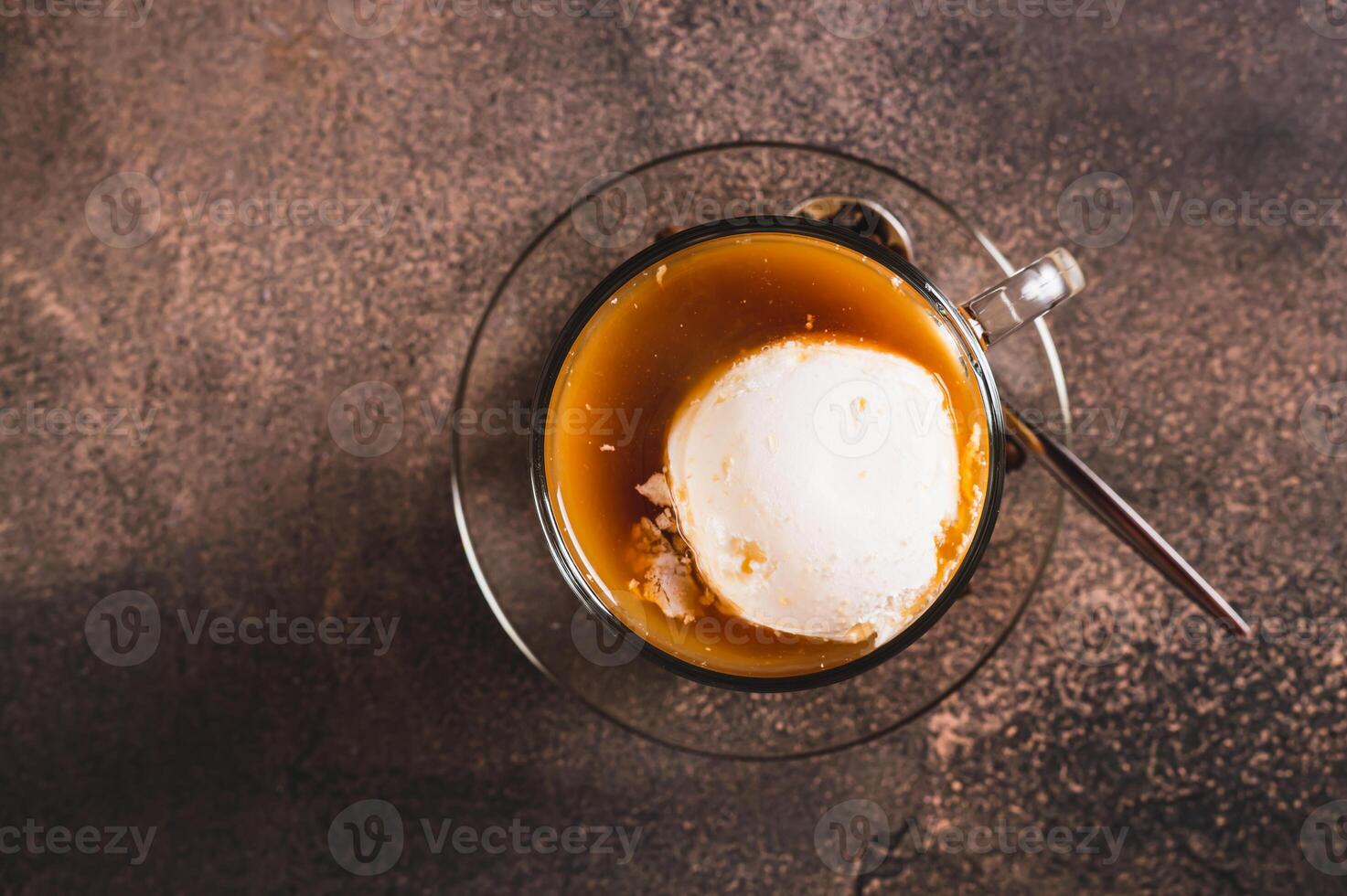 Close up of delicious sweet affogato coffee with creamy ice cream in a cup on the table top view photo
