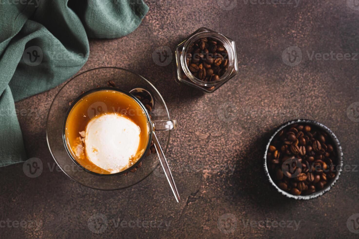 Delicious sweet affogato coffee with creamy ice cream in a cup on the table top view photo