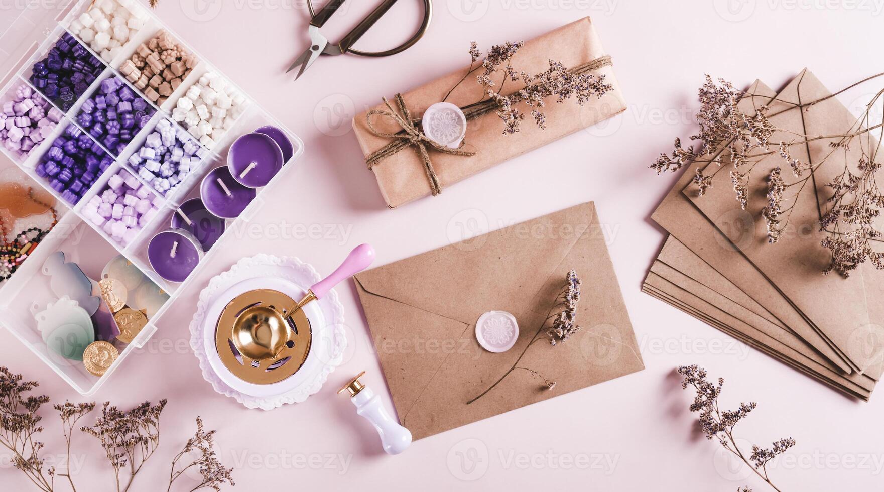 Creative set for sealing envelopes and gifts with wax seal on pink top view web banner photo