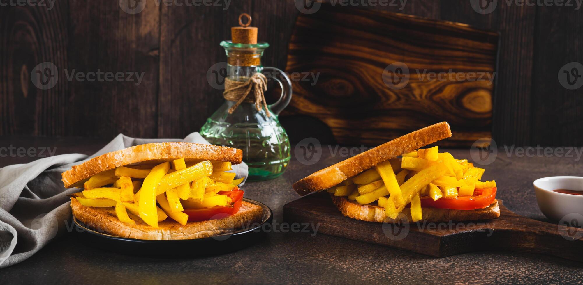 Fried toasts with french fries and tomato on a board on the table web banner photo