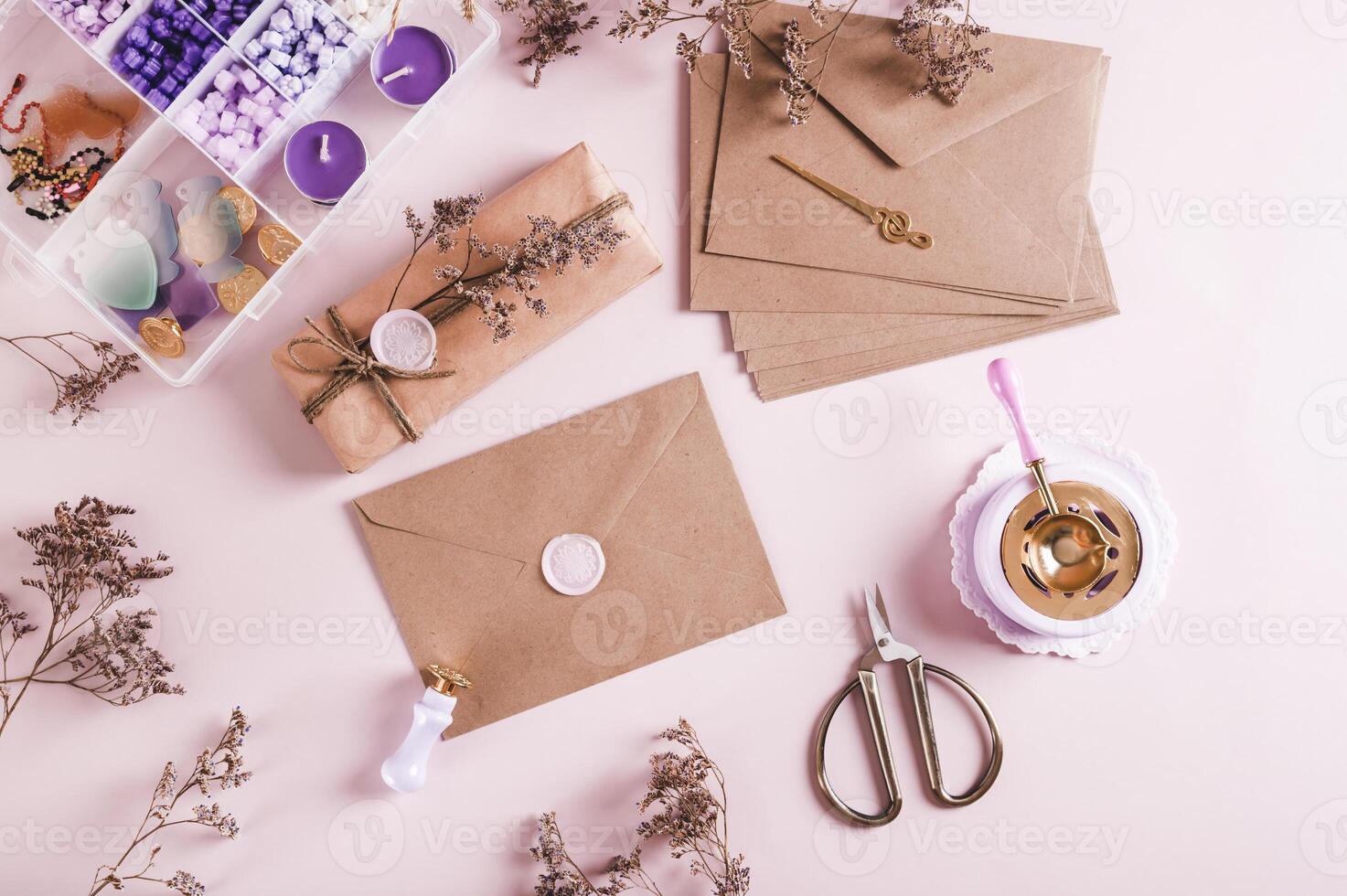 An envelope sealed with wax and a craft kit on the table top view photo
