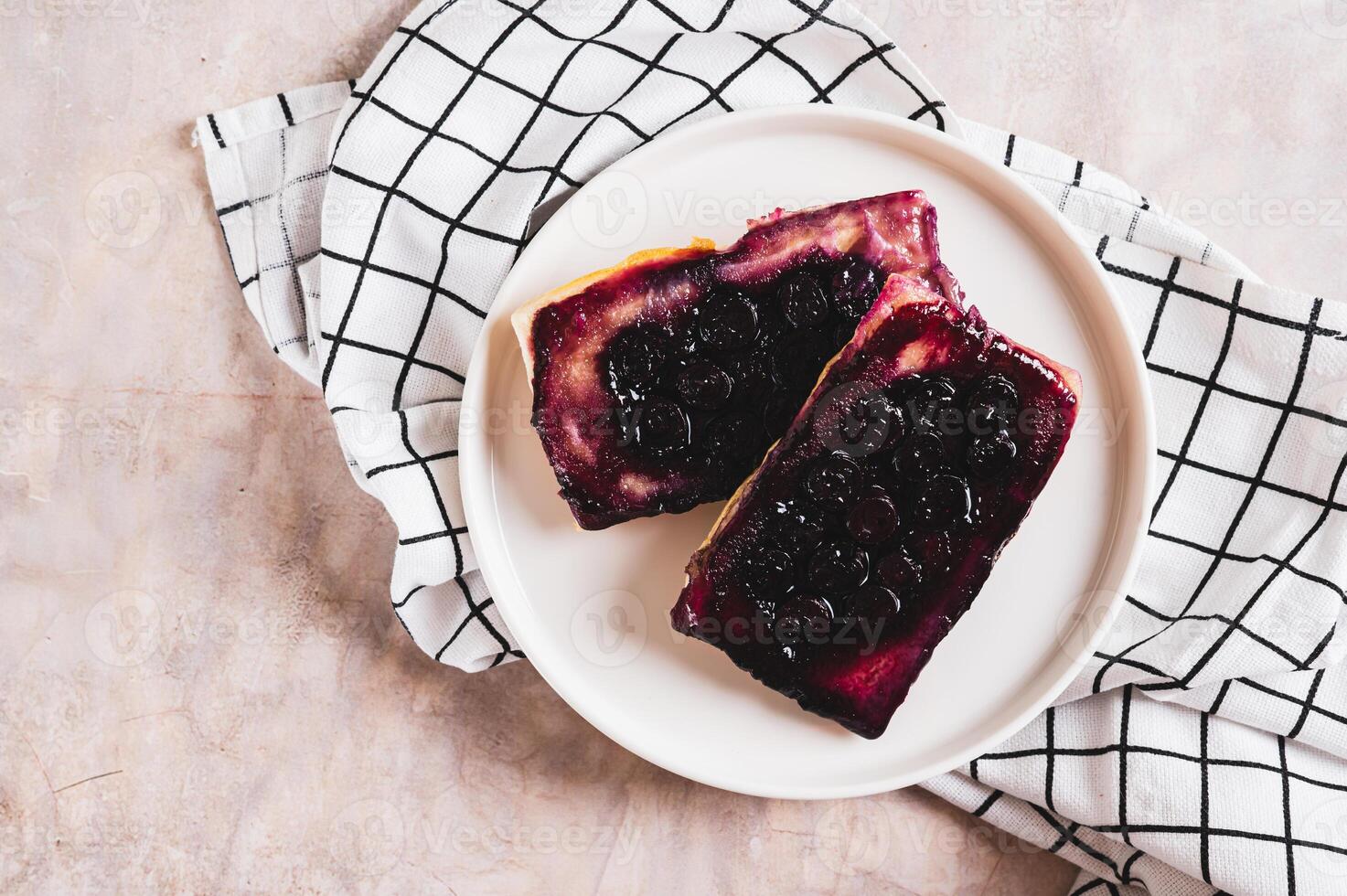 Close up of blueberry upside down pies on a plate on a table top view photo