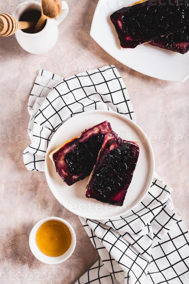 Delicious upside down berry pies on a plate on the table top and vertical view photo