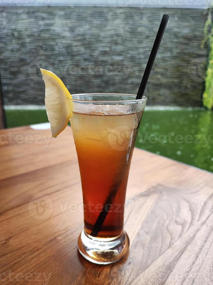 Refreshing Iced Tea with Lemon Slice and a Straw photo