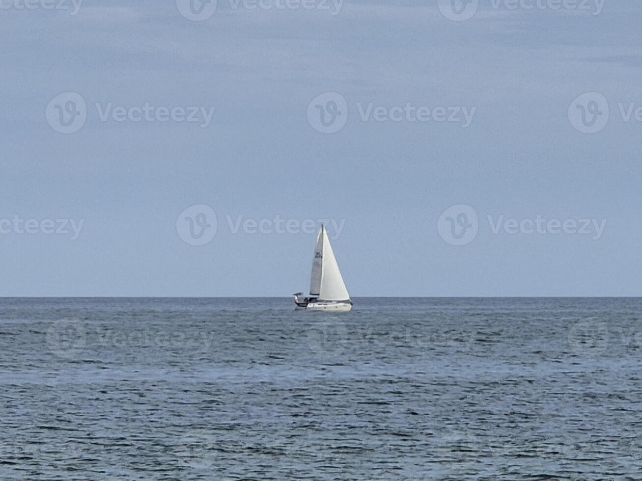 White sailboat in the open sea creative background photo