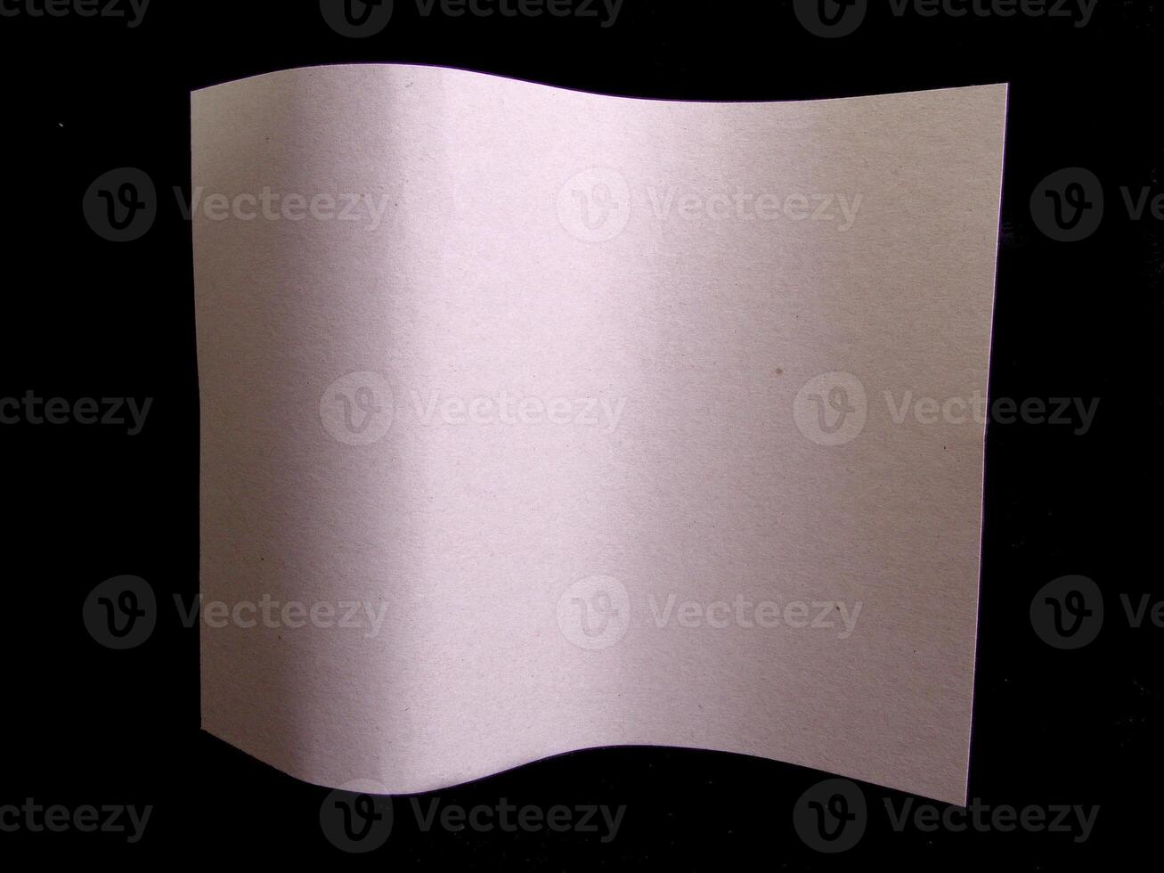 Wavy paper sheet over black background creative background photo