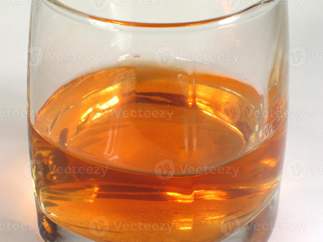 Glass of whiskey on white background creative wallpaper photo