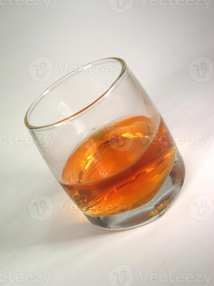 Glass of whiskey on white background creative background photo