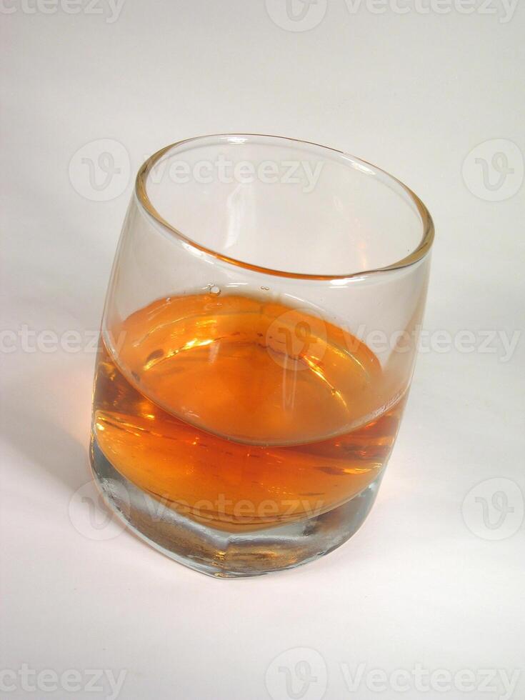 Glass of whiskey on white background wallpaper photo
