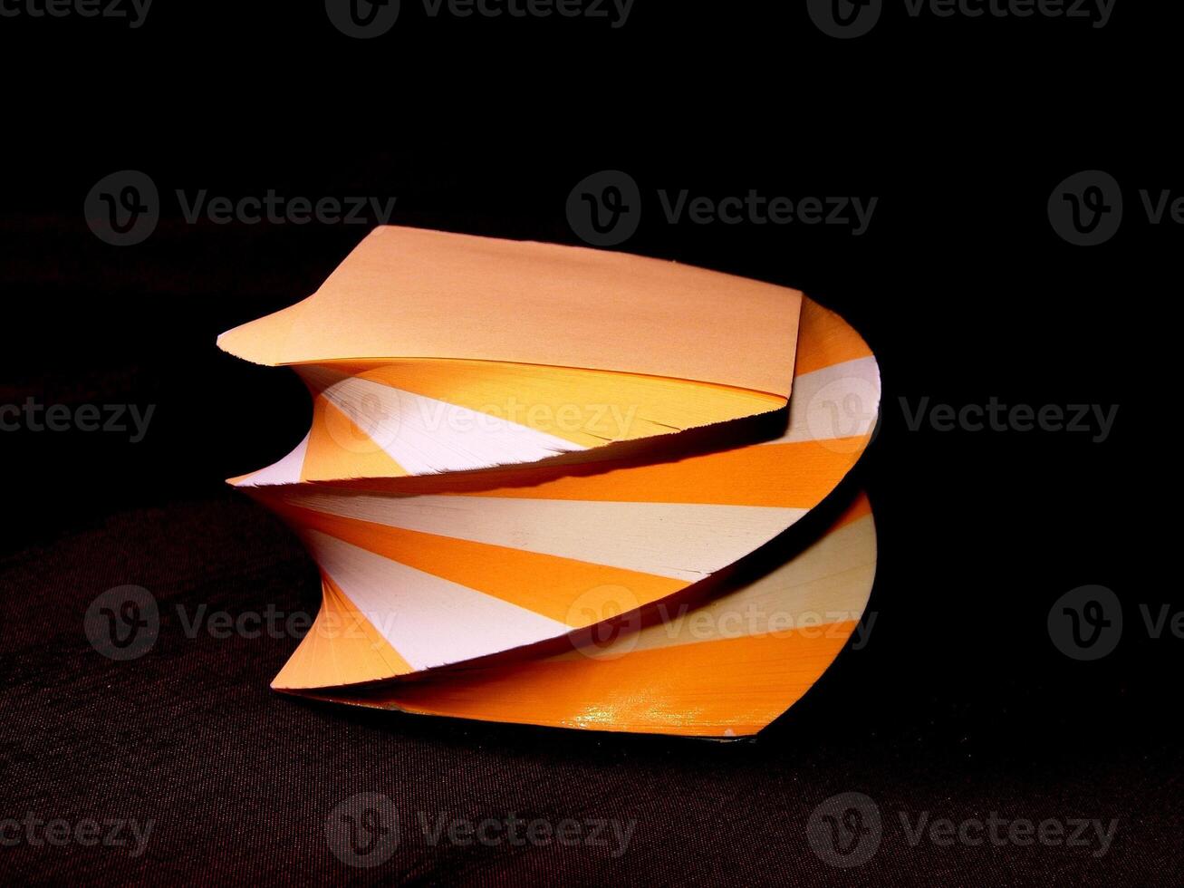 Orange and white papers for notes organized in a form of decorative towers wallpaper photo