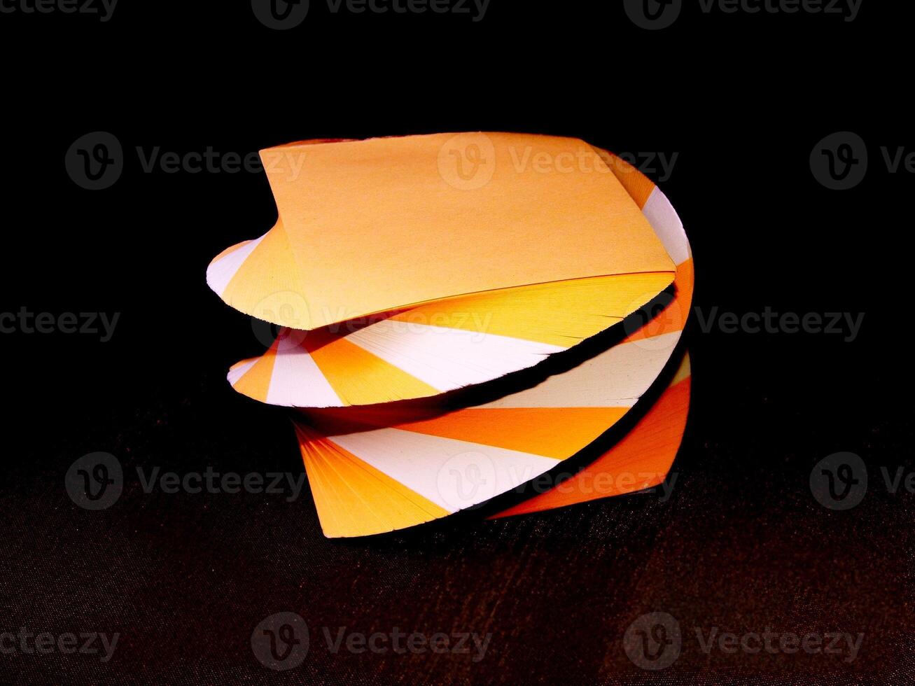 Orange and white papers for notes organized in a form of decorative towers creative background photo