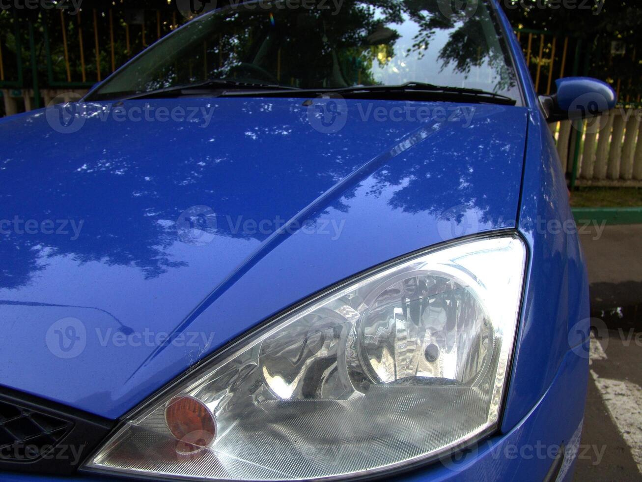 Modern Blue Car Headlight Close Up photo