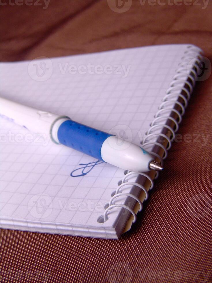 Empty notebook and a pen background creative background photo