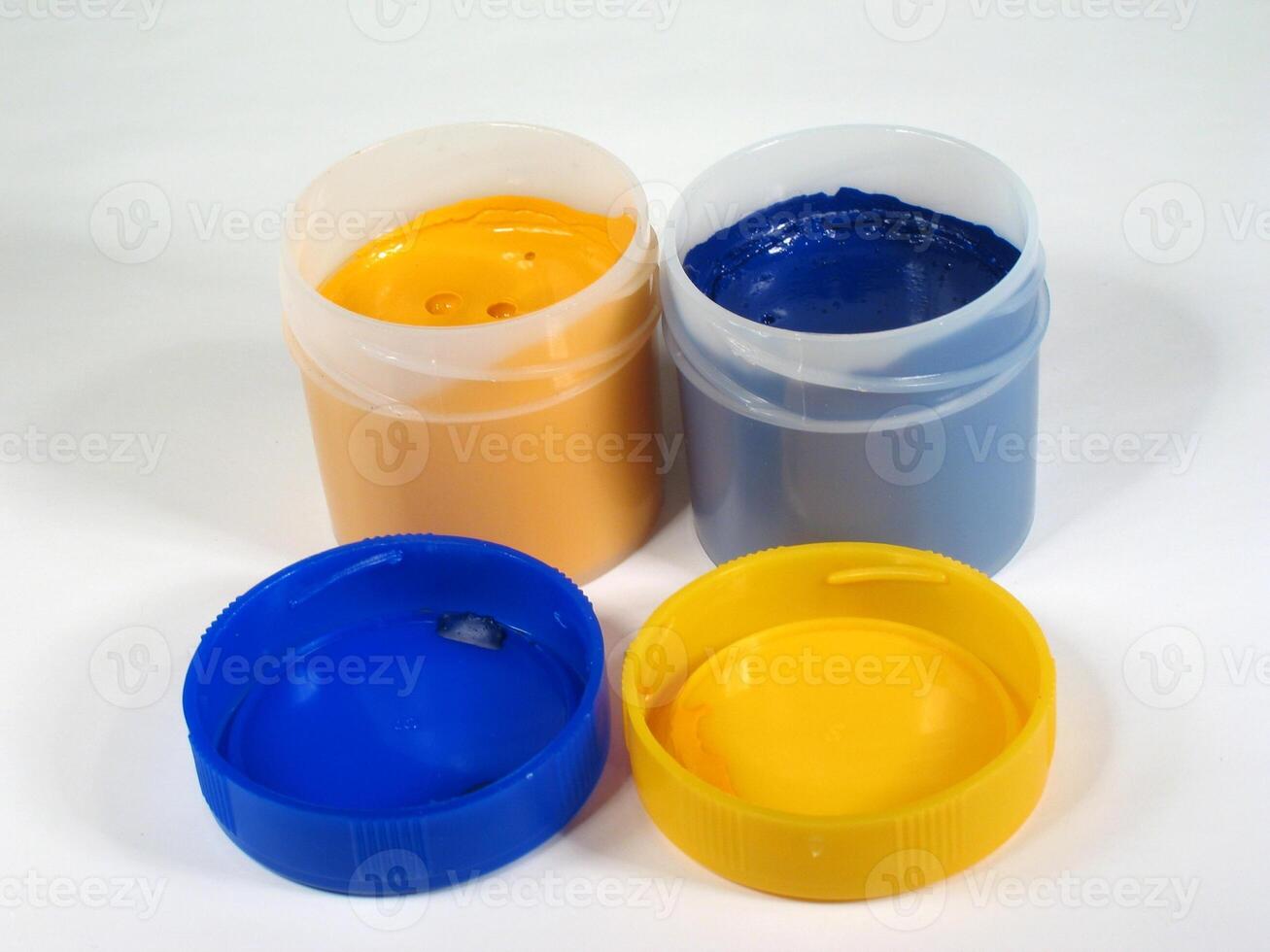 Colored paint cans over white background designer wallpaper photo
