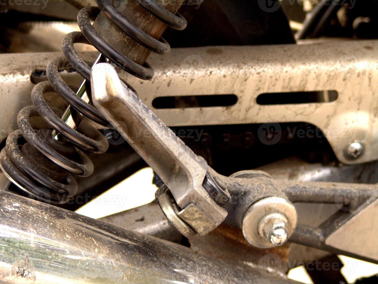 Rear Footpeg and Suspension Spring of a Motorcycle photo