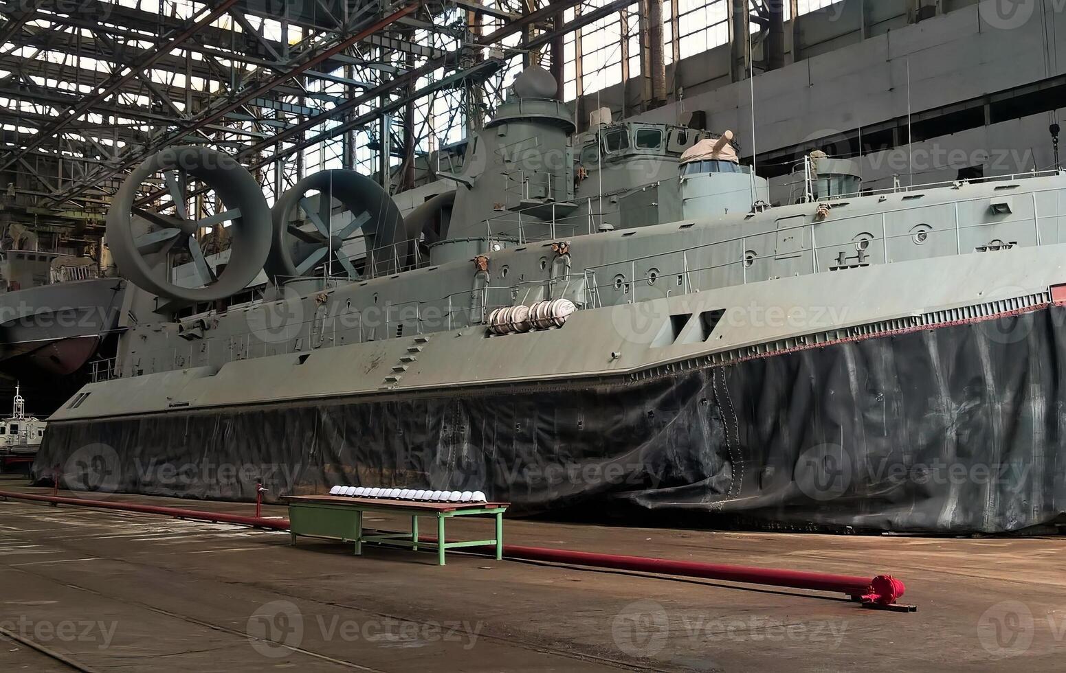 Military hovercraft docked in hangar photo