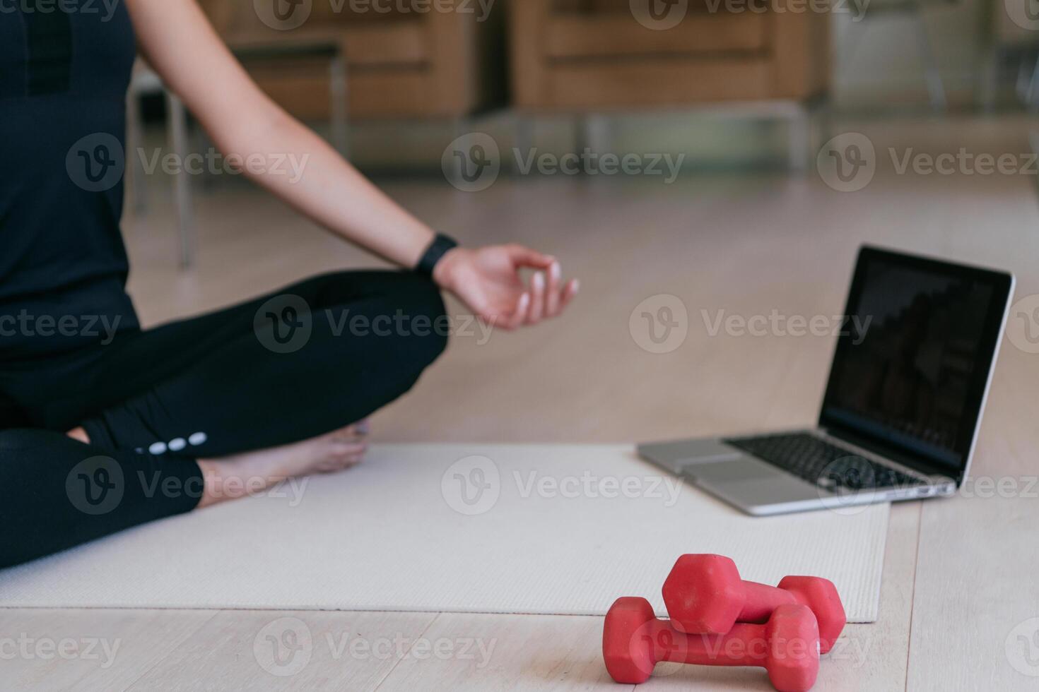 Young Beautiful Female Exercising, Stretching and Practising Yoga with Trainer via Call Conference in Bright Sunny House. Healthy Lifestyle, Wellbeing and Mindfulness Concept. photo