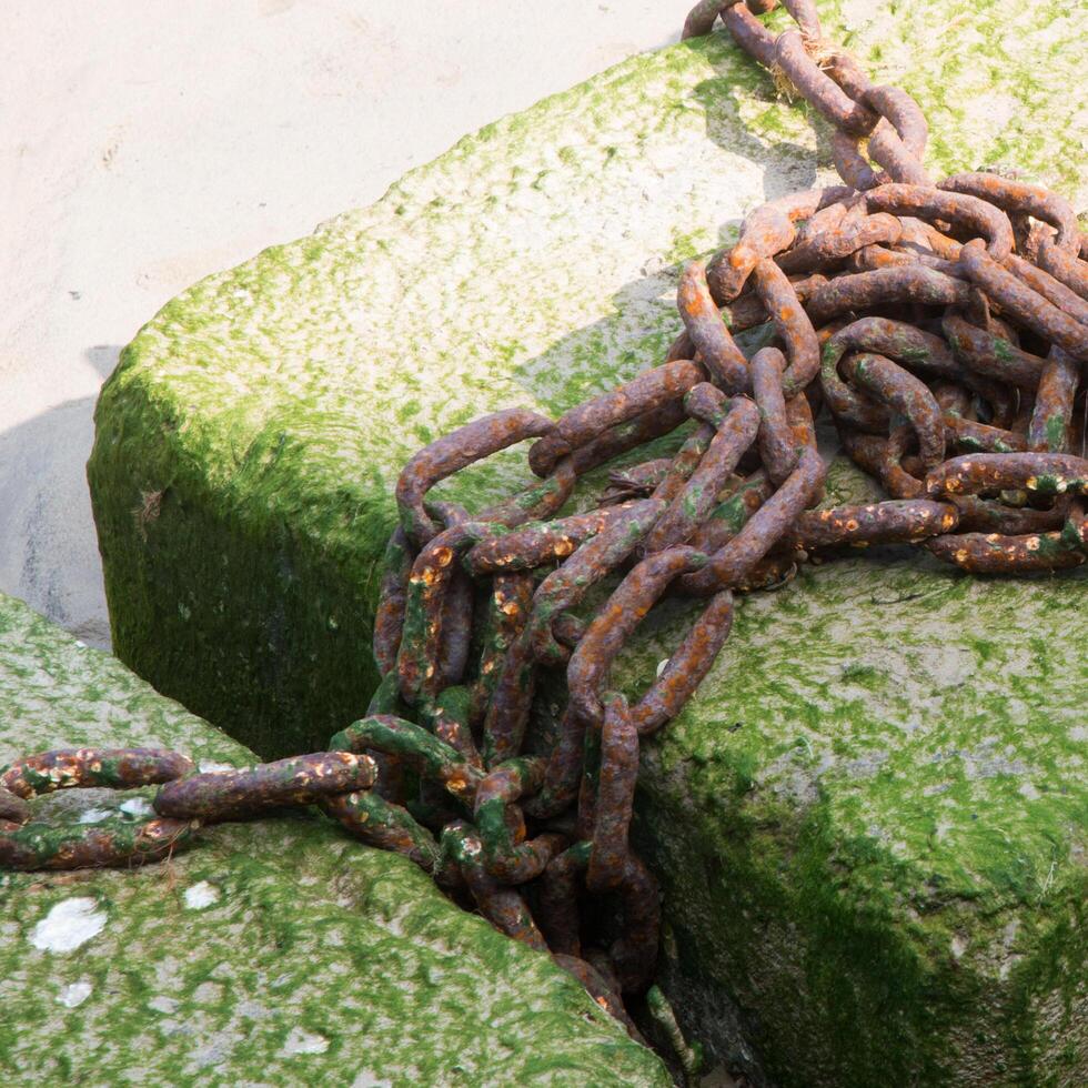 Rusty chain on the harbour photo