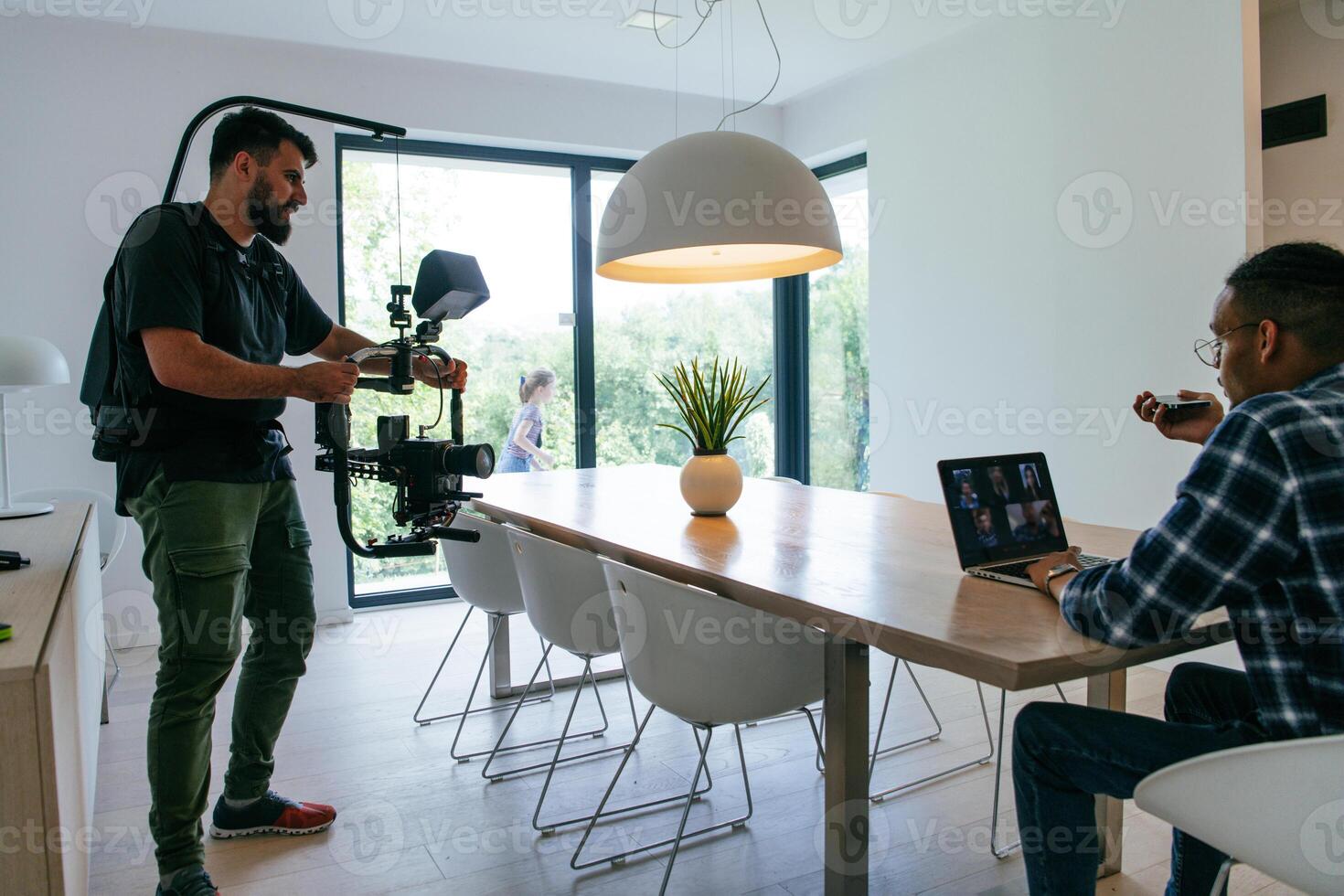 A cameraman talking with an African American man as they preparing to shoot a commercial . High quality photo