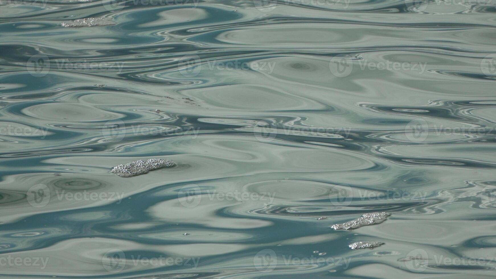 Water Ripples Texture Abstract Background - Closeup of blue and white water ripples creating an abstract background texture. photo