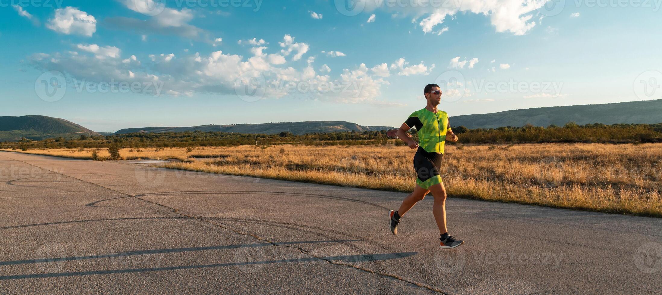 Triathlete in professional gear running early in the morning, preparing for a marathon, dedication to sport and readiness to take on the challenges of a marathon. photo