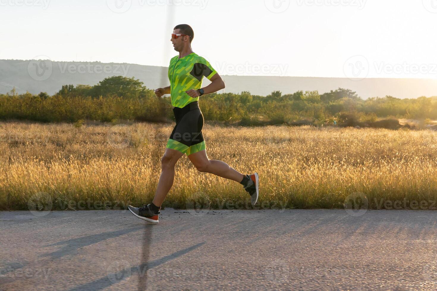 Triathlete in professional gear running early in the morning, preparing for a marathon, dedication to sport and readiness to take on the challenges of a marathon. photo