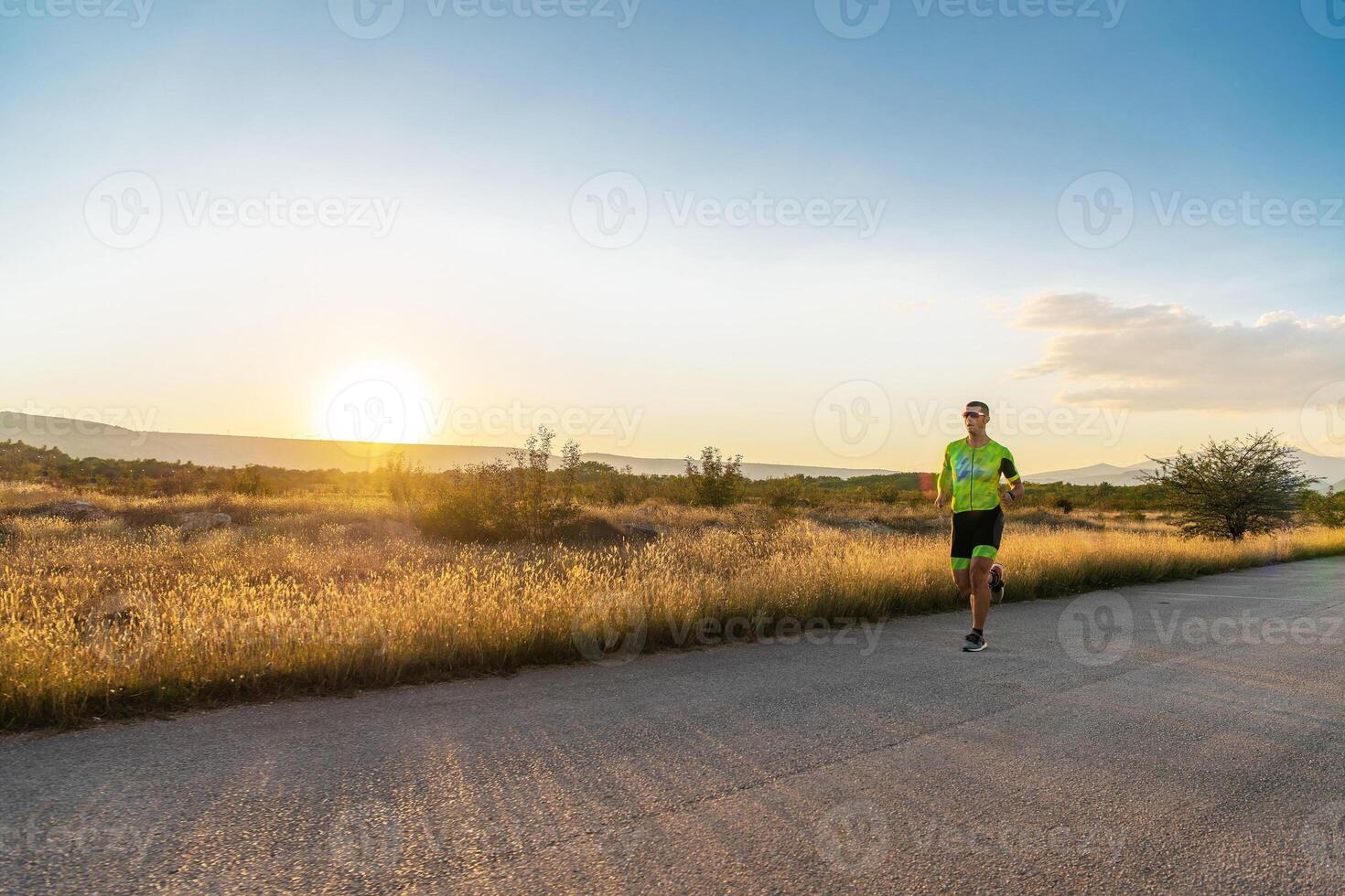 Triathlete in professional gear running early in the morning, preparing for a marathon, dedication to sport and readiness to take on the challenges of a marathon. photo