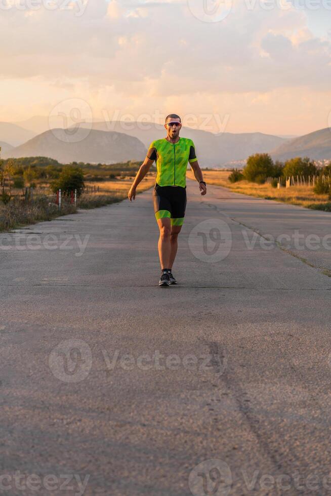 Triathlete in professional gear running early in the morning, preparing for a marathon, dedication to sport and readiness to take on the challenges of a marathon. photo