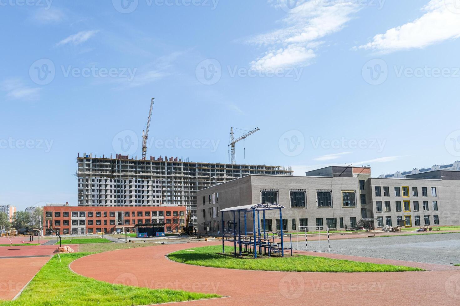 A Playground against the background of construction projects in a new residential area photo