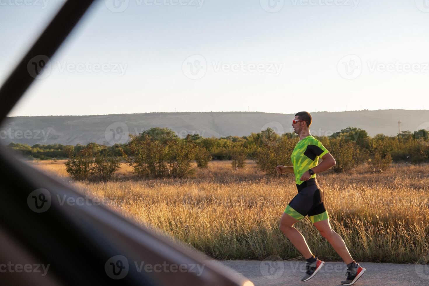 Triathlete in professional gear running early in the morning, preparing for a marathon, dedication to sport and readiness to take on the challenges of a marathon. photo