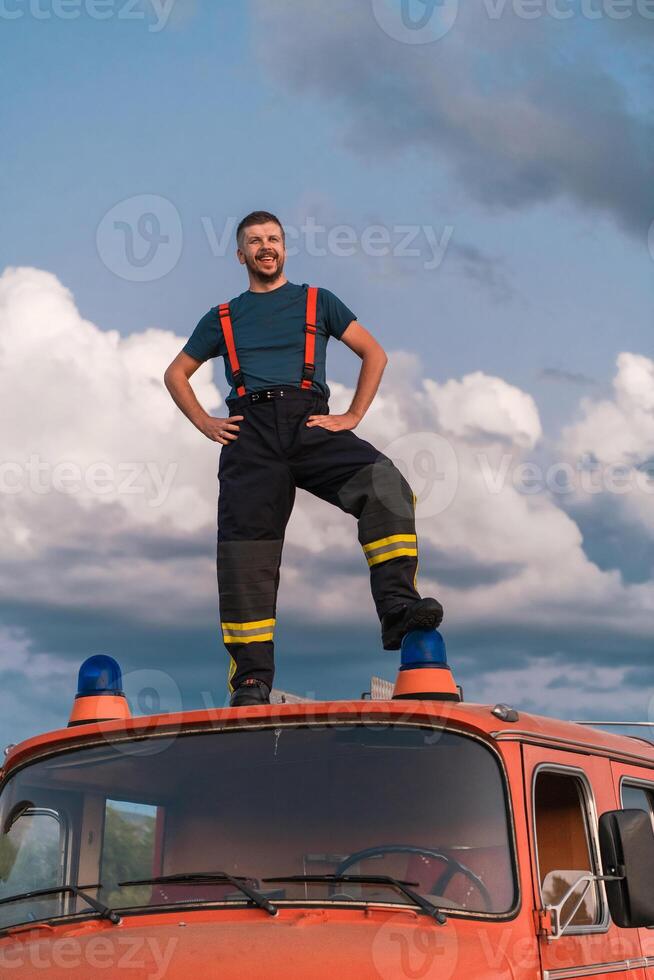 The firefighter standing confidently on the fire truck, ready to respond to any emergency. photo