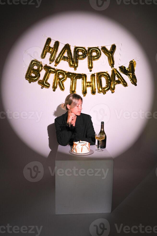 Stylish birthday photo zone girl looking at champagne