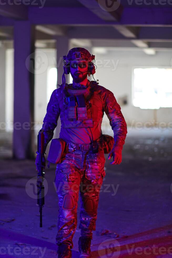 A professional soldier undertakes a perilous mission in an abandoned building illuminated by neon blue and purple lights photo