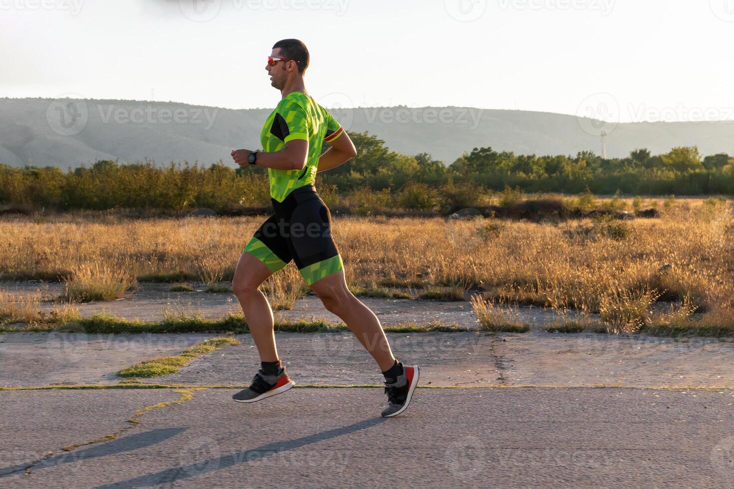 Triathlete in professional gear running early in the morning, preparing for a marathon, dedication to sport and readiness to take on the challenges of a marathon. photo