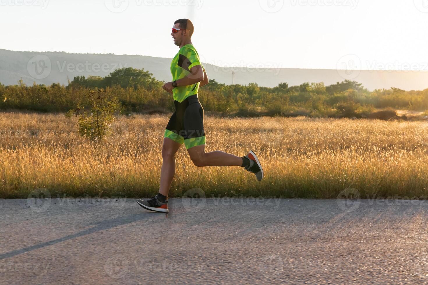 Triathlete in professional gear running early in the morning, preparing for a marathon, dedication to sport and readiness to take on the challenges of a marathon. photo