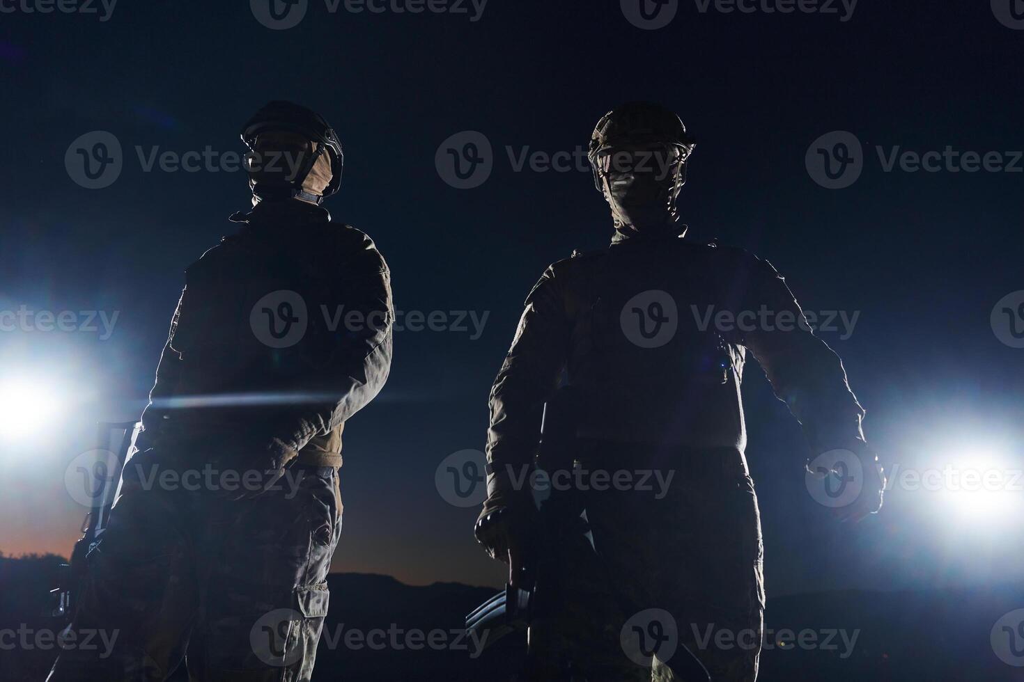 Two professional soldiers marching through the dark of night on a dangerous mission, epitomizing their unwavering bravery, unwavering teamwork, and the high-stakes intensity of their specialized photo