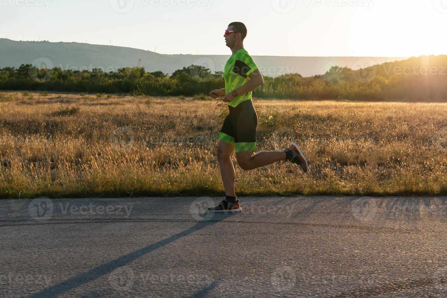 Triathlete in professional gear running early in the morning, preparing for a marathon, dedication to sport and readiness to take on the challenges of a marathon. photo