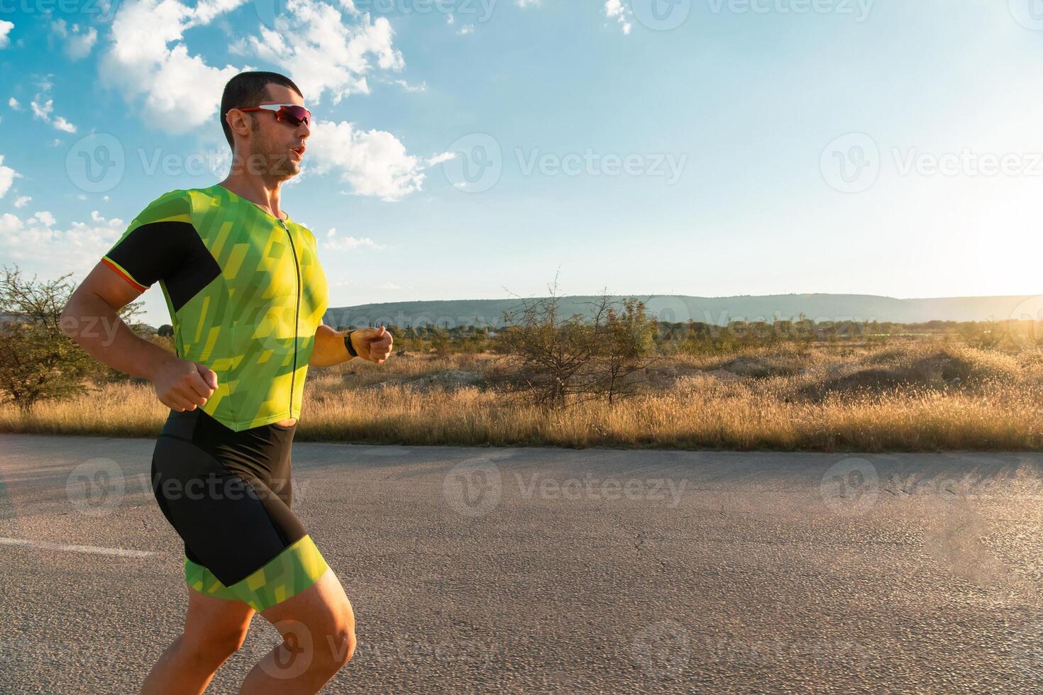 Triathlete in professional gear running early in the morning, preparing for a marathon, dedication to sport and readiness to take on the challenges of a marathon. photo