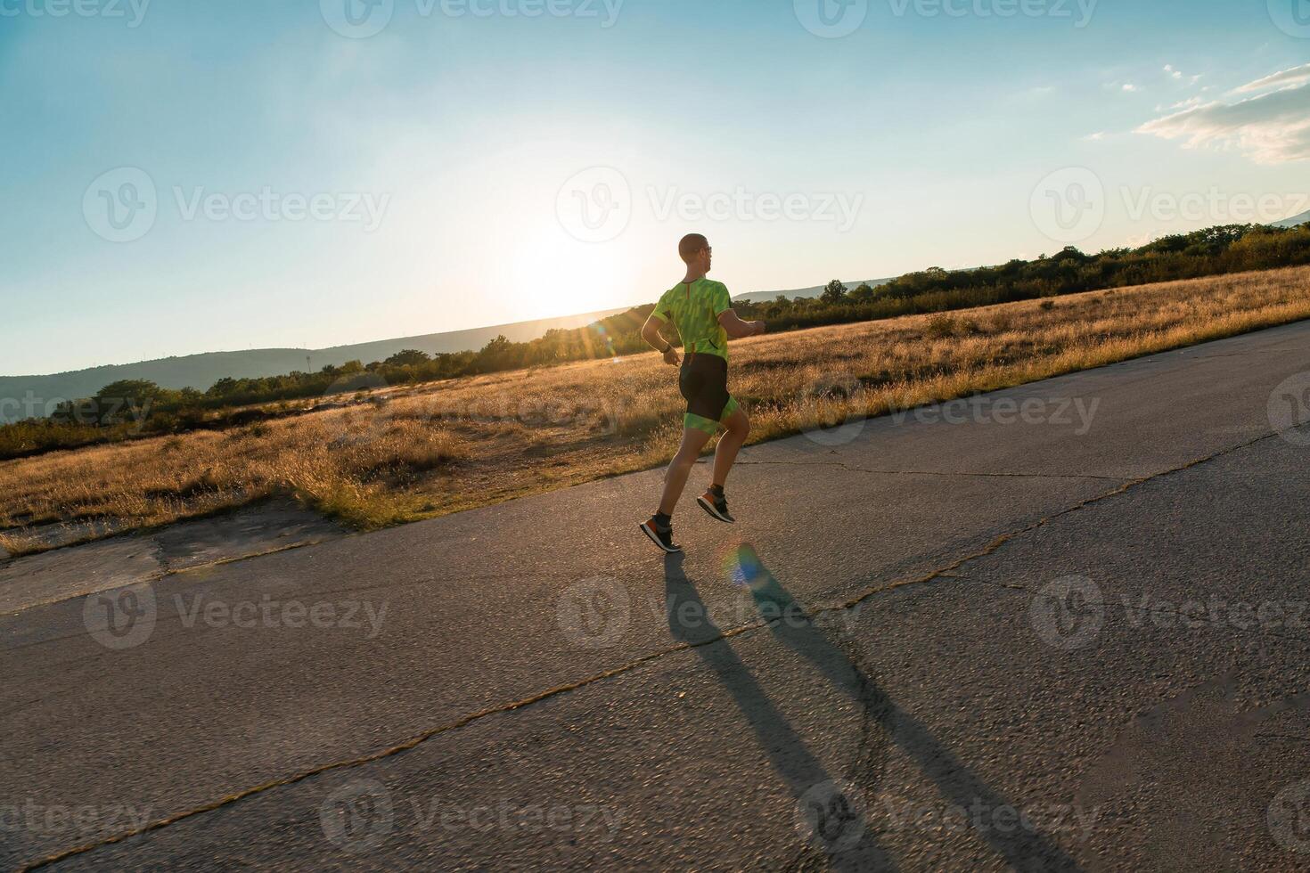 Triathlete in professional gear running early in the morning, preparing for a marathon, dedication to sport and readiness to take on the challenges of a marathon. photo