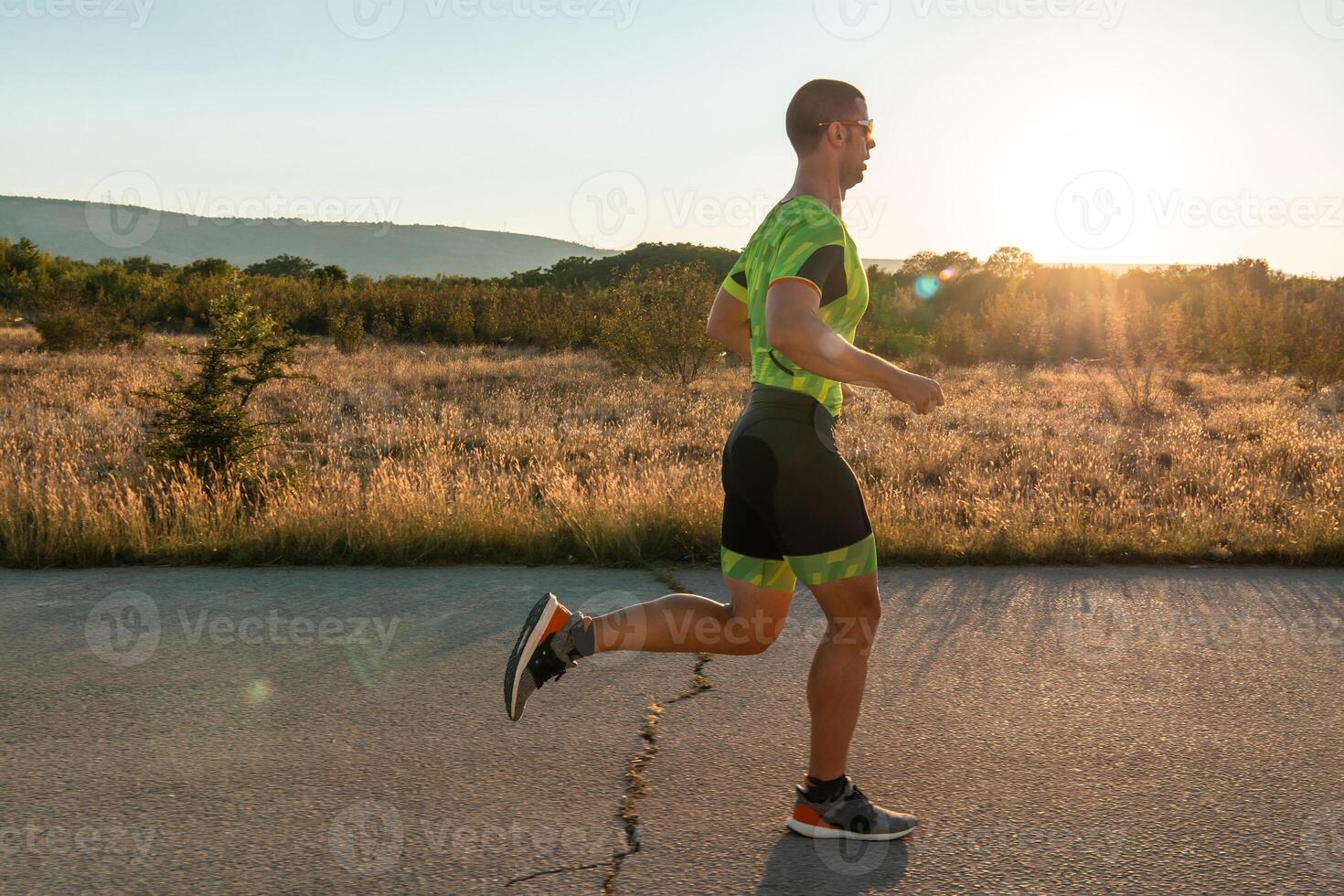 Triathlete in professional gear running early in the morning, preparing for a marathon, dedication to sport and readiness to take on the challenges of a marathon. photo