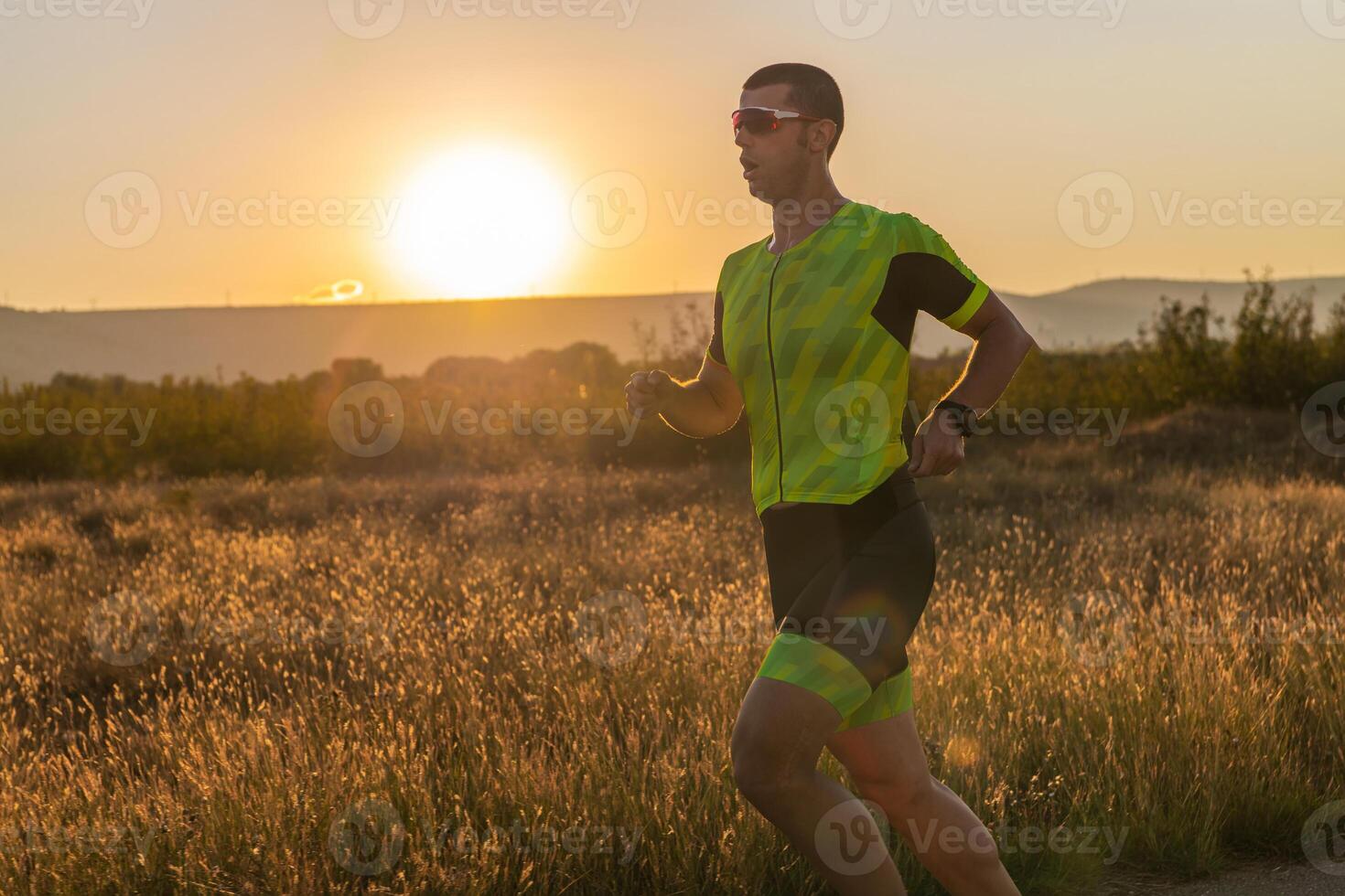 Triathlete in professional gear running early in the morning, preparing for a marathon, dedication to sport and readiness to take on the challenges of a marathon. photo